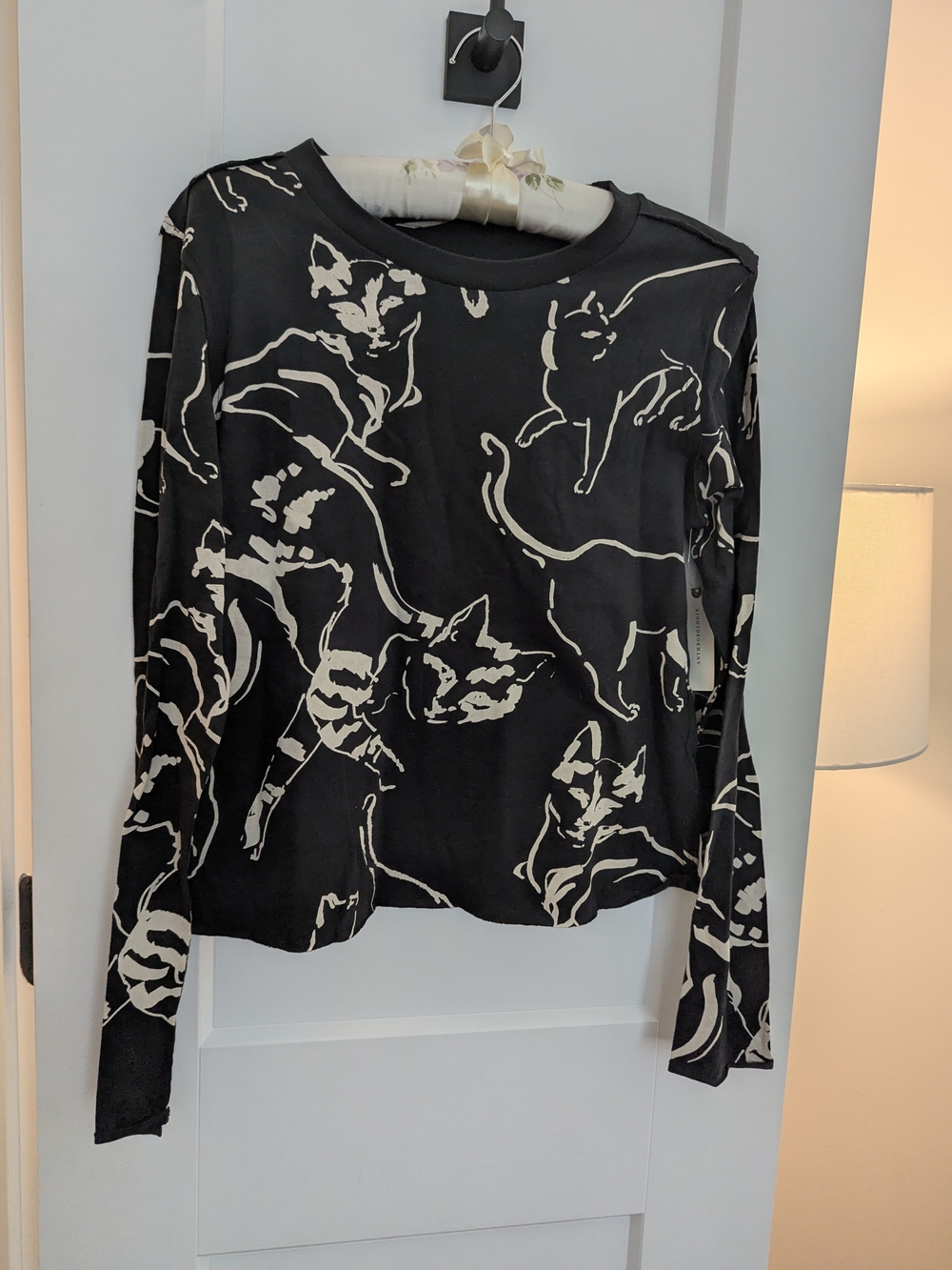 Anthropologie Black Long-Sleeve Tee with Cream Cat Outline Pattern